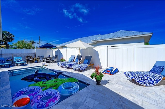 exterior space featuring outdoor dining area and a fenced backyard