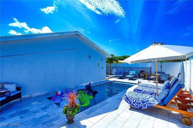 view of swimming pool with a fenced backyard and a patio area