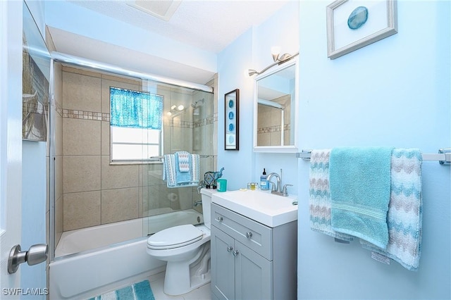 full bathroom with vanity, toilet, visible vents, and shower / bath combination with glass door