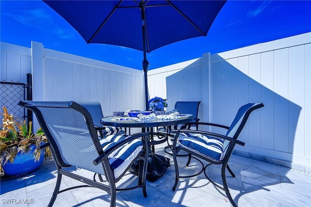 view of patio / terrace featuring outdoor dining area and fence