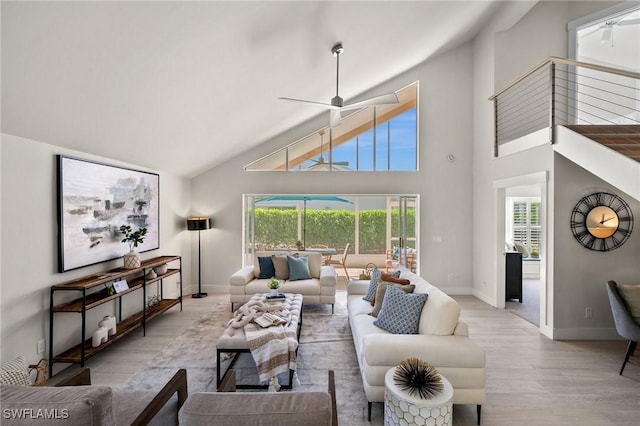 1590 Weybridge Cir Unit 52, Naples, FL 34110 - living area with wood finished floors, baseboards, high vaulted ceiling, and a ceiling fan