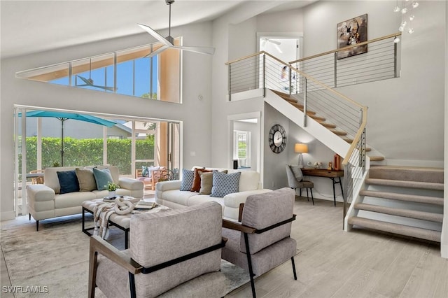 1590 Weybridge Cir Unit 52, Naples, FL 34110 - living area with stairs, baseboards, a towering ceiling, wood finished floors, and ceiling fan