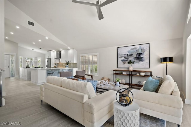 1590 Weybridge Cir Unit 52, Naples, FL 34110 - living room with vaulted ceiling, recessed lighting, light wood-style flooring, baseboards, and ceiling fan