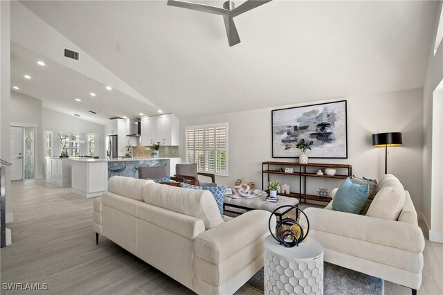 1590 Weybridge Cir Unit 52, Naples, FL 34110 - living room with vaulted ceiling, recessed lighting, light wood-type flooring, and ceiling fan