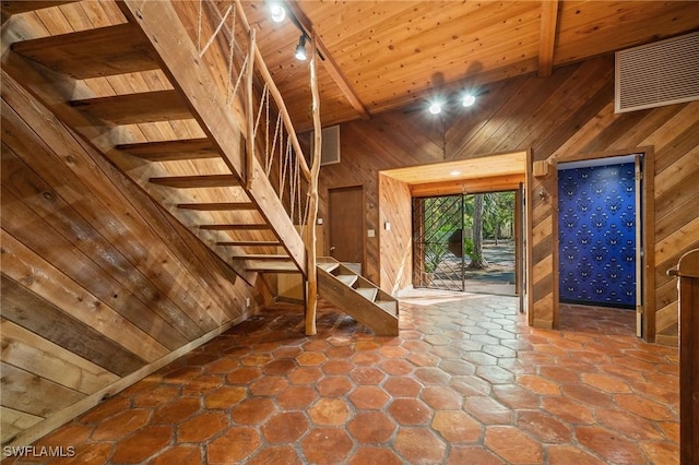 3775 27th Ave SW, Naples, FL 34117 - foyer featuring wood walls, a wood ceiling with exposed beams, rail lighting, stairway, and high vaulted ceiling