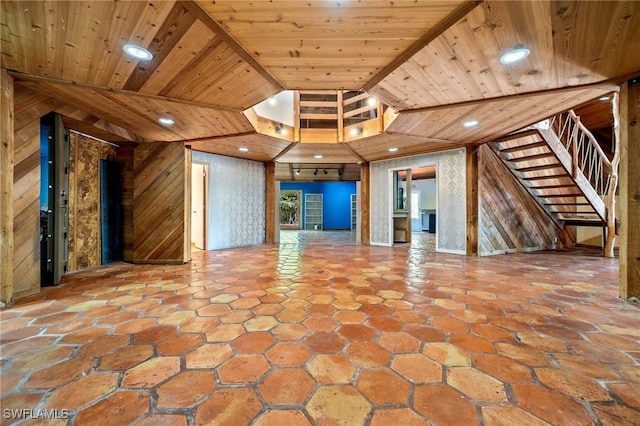 3775 27th Ave SW, Naples, FL 34117 - unfurnished living room featuring wooden walls, stairs, and wooden ceiling