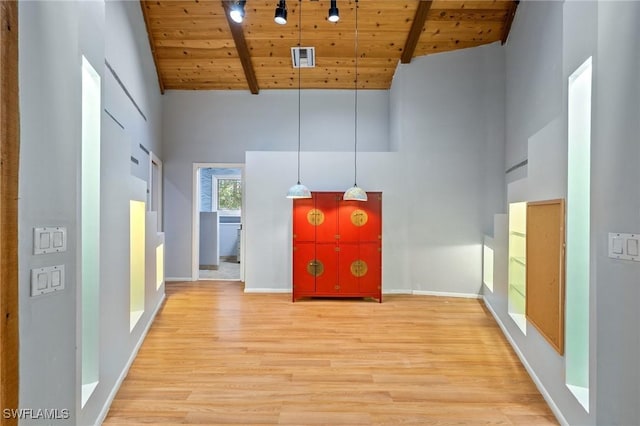 3775 27th Ave SW, Naples, FL 34117 - unfurnished living room with a wood ceiling with exposed beams, high vaulted ceiling, and light wood-style floors