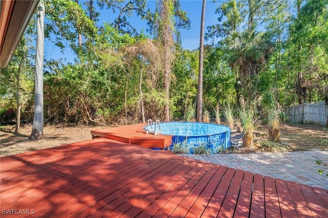 3775 27th Ave SW, Naples, FL 34117 - wooden deck with fence and an outdoor pool