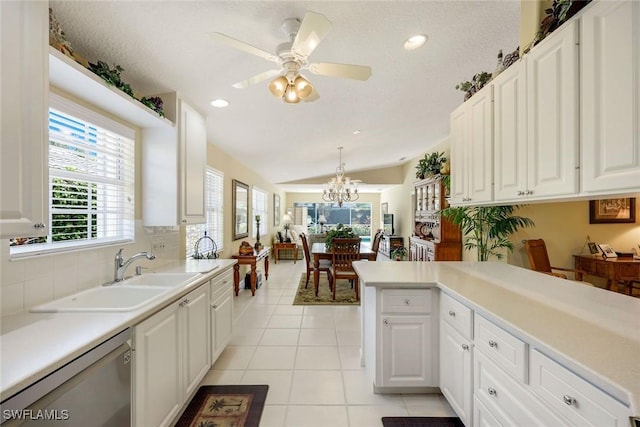 4221 Saint George Ln, Naples, FL 34119 - kitchen with light countertops, lofted ceiling, light tile patterned floors, stainless steel dishwasher, and a sink