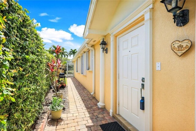 4221 Saint George Ln, Naples, FL 34119 - doorway to property featuring stucco siding