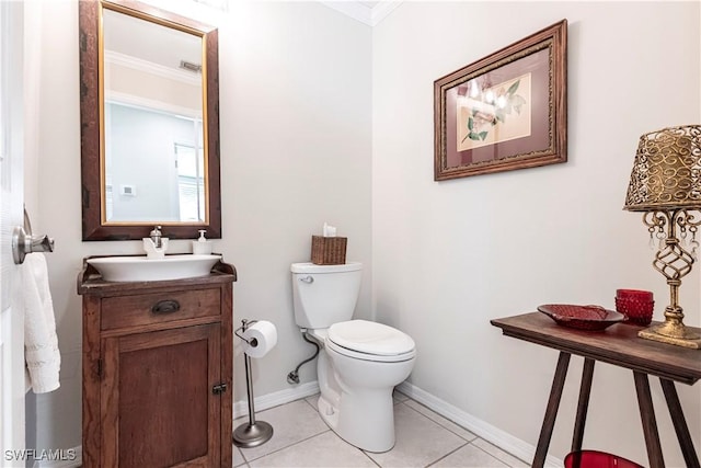 183 Old Tamiami Trl, Naples, FL 34110 - bathroom with ornamental molding, toilet, tile patterned floors, baseboards, and vanity