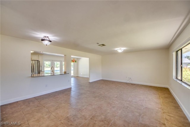 17225 Castleview Dr, North Fort Myers, FL 33917 - unfurnished room featuring french doors, plenty of natural light, baseboards, and visible vents