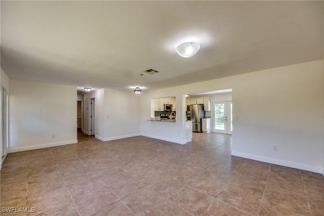 17225 Castleview Dr, North Fort Myers, FL 33917 - unfurnished living room with baseboards and visible vents