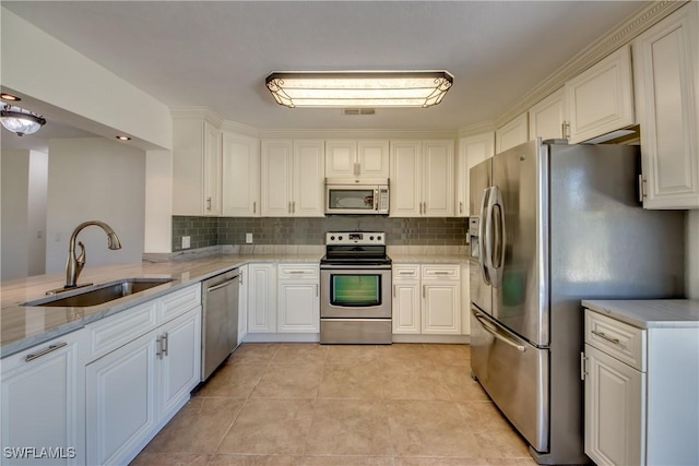 17225 Castleview Dr, North Fort Myers, FL 33917 - kitchen featuring light tile patterned floors, a sink, stainless steel appliances, and tasteful backsplash