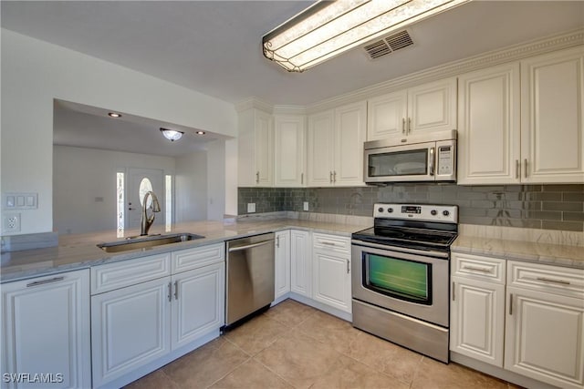 17225 Castleview Dr, North Fort Myers, FL 33917 - kitchen featuring a sink, stainless steel appliances, light tile patterned floors, visible vents, and white cabinets