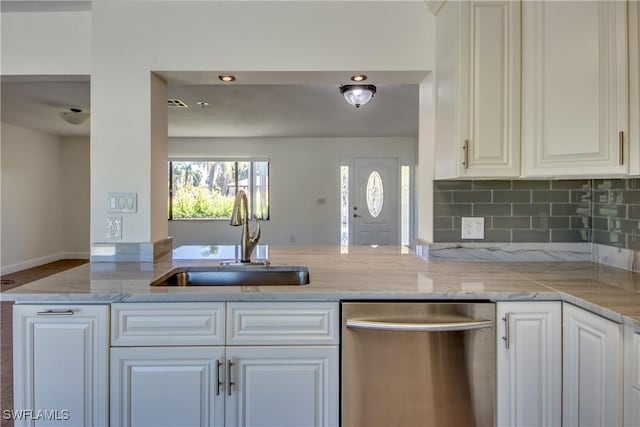 17225 Castleview Dr, North Fort Myers, FL 33917 - kitchen featuring white cabinets, a peninsula, dishwasher, light stone countertops, and a sink