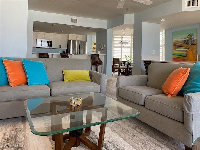 living room with visible vents and ceiling fan