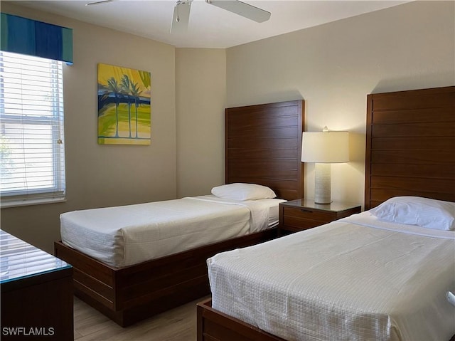 bedroom featuring light wood-type flooring and a ceiling fan