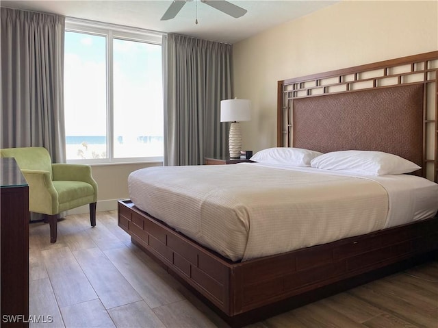 bedroom with ceiling fan and wood finished floors