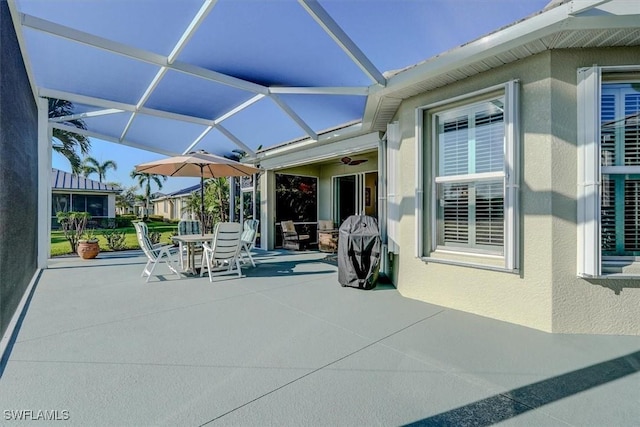 view of patio / terrace with outdoor dining area and glass enclosure