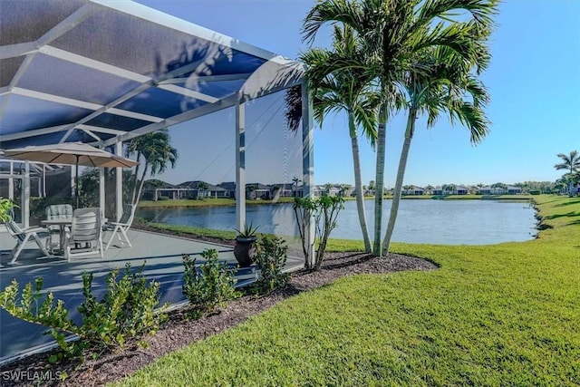 exterior space with a yard, a water view, a lanai, and a patio area