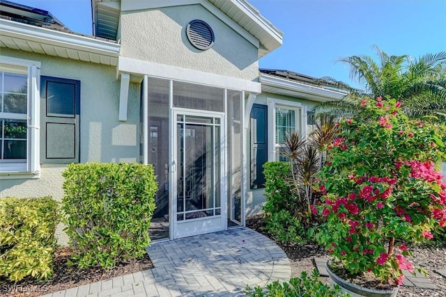 property entrance featuring stucco siding