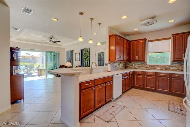 kitchen with visible vents, dishwasher, a raised ceiling, and a sink