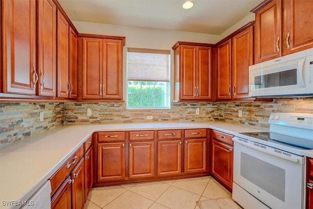 kitchen with decorative backsplash, white appliances, brown cabinets, and light countertops