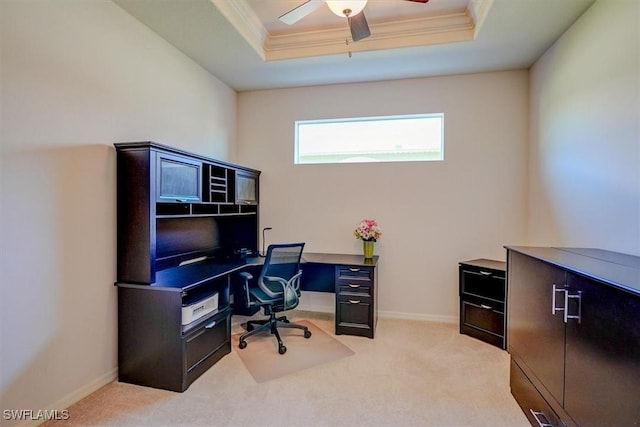 office space with a raised ceiling, crown molding, light colored carpet, and ceiling fan