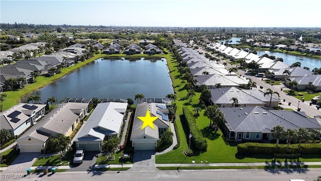 drone / aerial view featuring a residential view and a water view