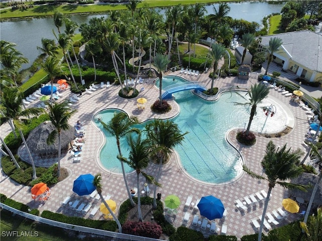 community pool featuring a hot tub, a patio, and a water view