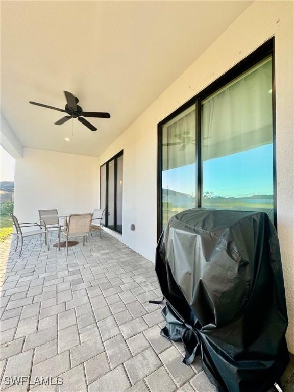 view of patio / terrace with outdoor dining space and a ceiling fan