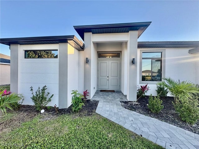 doorway to property with stucco siding