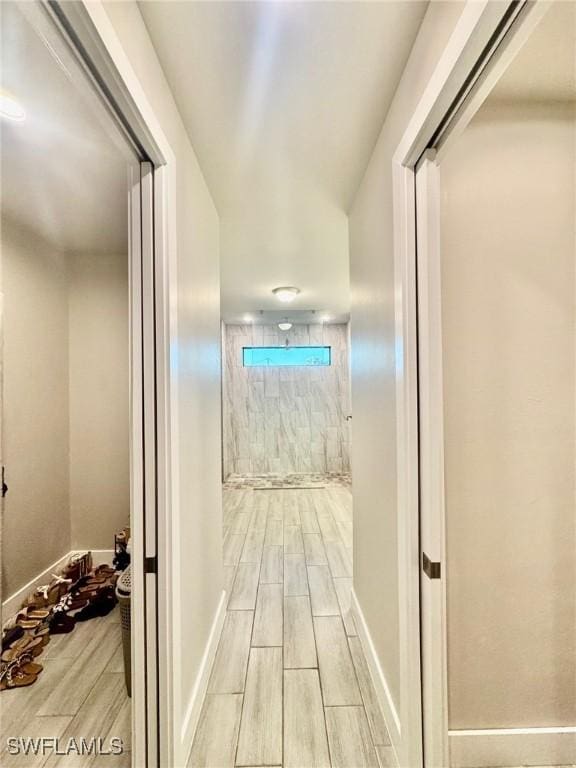 bathroom featuring baseboards and wood tiled floor