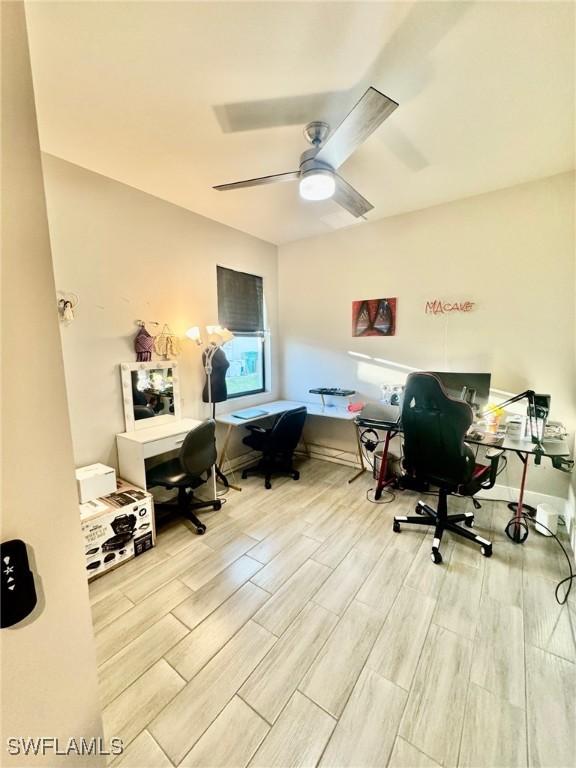 office space featuring a ceiling fan and wood tiled floor