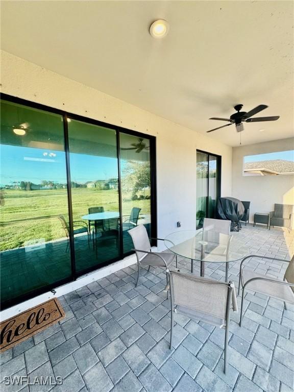 view of patio featuring outdoor dining area and ceiling fan