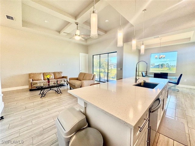 kitchen featuring a sink, visible vents, coffered ceiling, and wood tiled floor