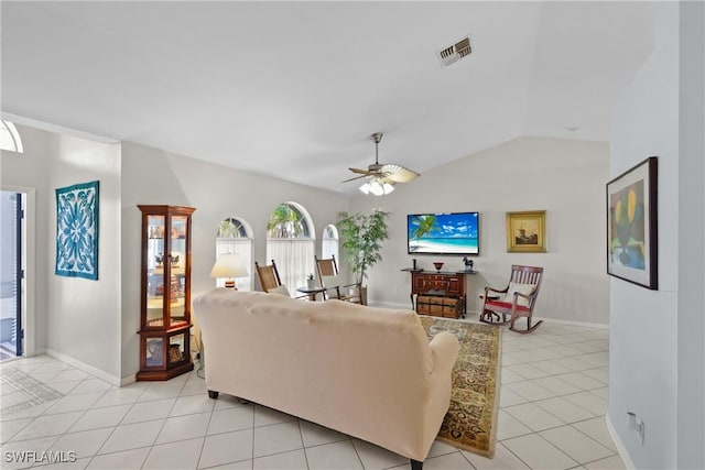 living room featuring visible vents, baseboards, vaulted ceiling, light tile patterned flooring, and a ceiling fan