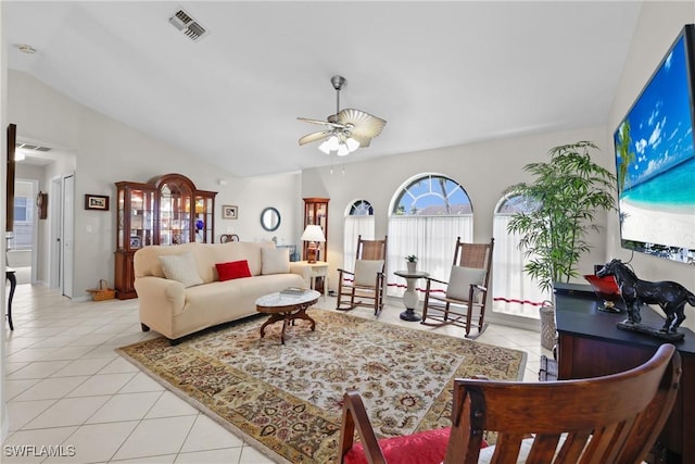 living room featuring vaulted ceiling, light tile patterned flooring, visible vents, and ceiling fan