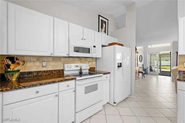 kitchen with light tile patterned flooring, backsplash, white appliances, and white cabinetry