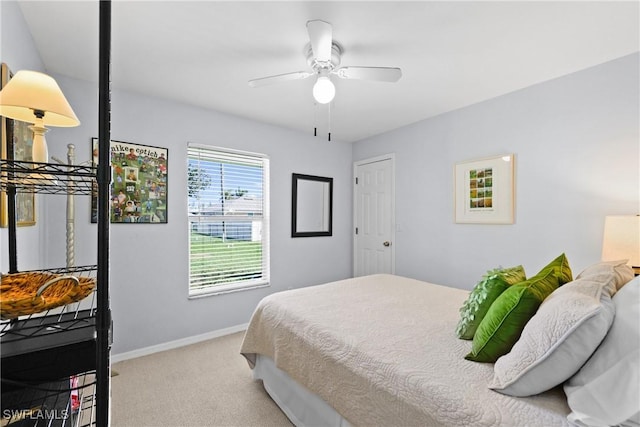 carpeted bedroom with a ceiling fan and baseboards