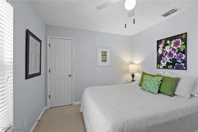 bedroom featuring visible vents, carpet floors, baseboards, and a ceiling fan