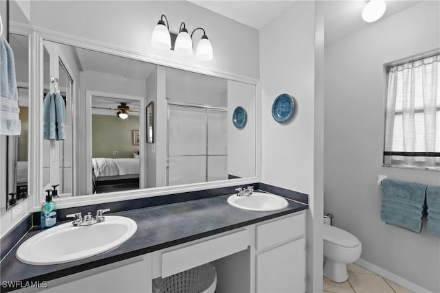 bathroom featuring tile patterned flooring, a shower stall, ensuite bathroom, and a sink