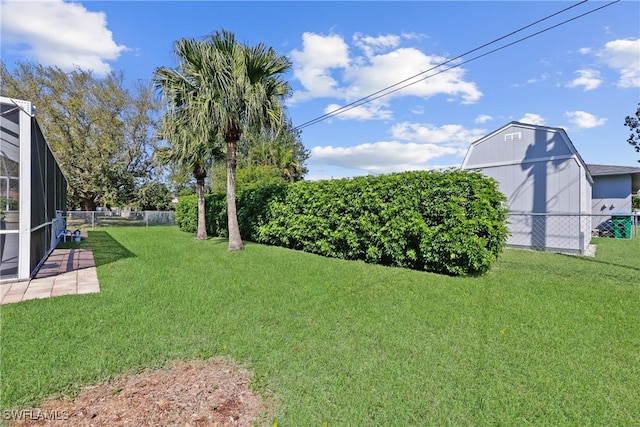 view of yard with a lanai and fence