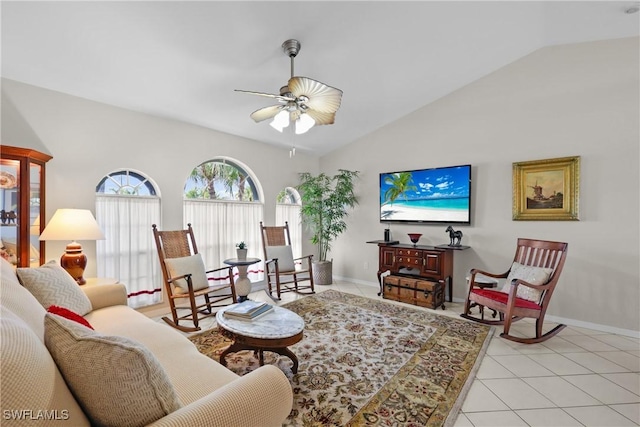 living room with light tile patterned floors, ceiling fan, baseboards, and lofted ceiling