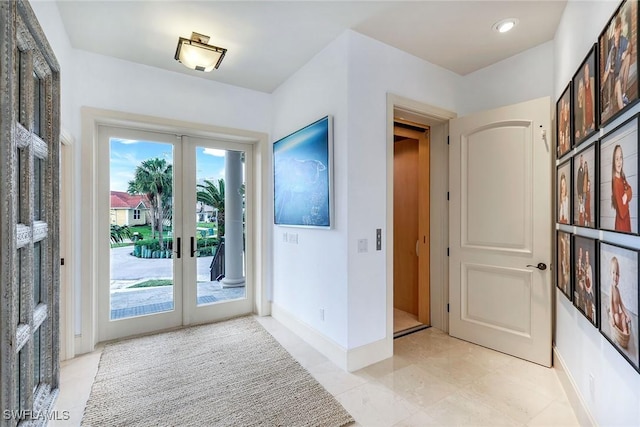 foyer entrance with recessed lighting, french doors, and baseboards