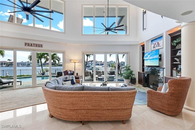 living room with visible vents, a high ceiling, and a premium fireplace