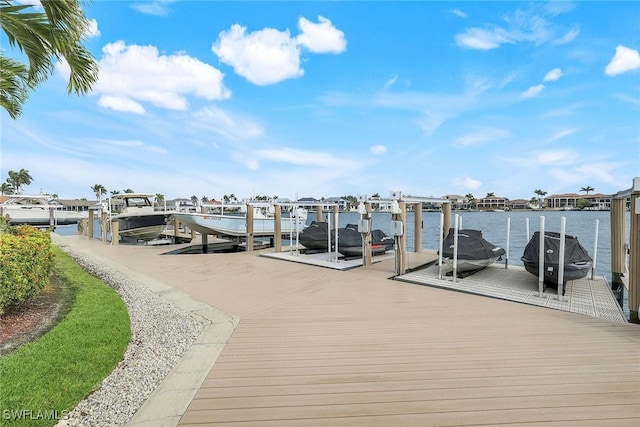 dock area featuring boat lift and a water view