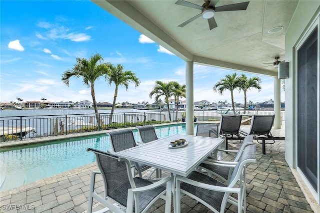 view of patio with outdoor dining space, a fenced backyard, a fenced in pool, and ceiling fan