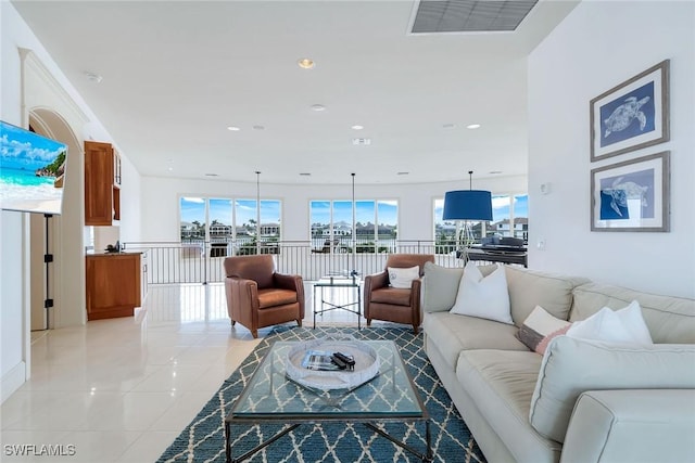 living area with recessed lighting, visible vents, and light tile patterned flooring